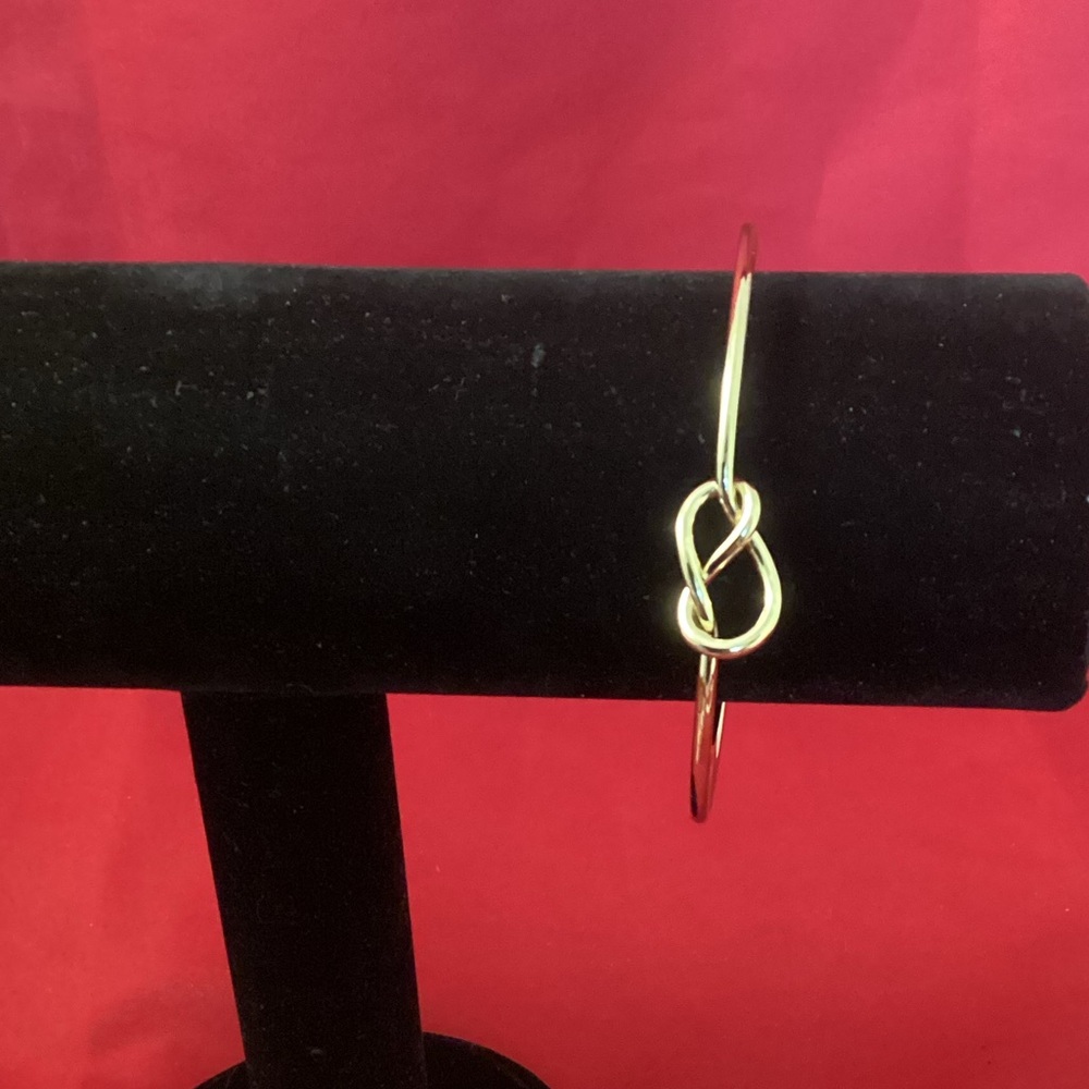 Gold tone nodded metallic cuff bracelet